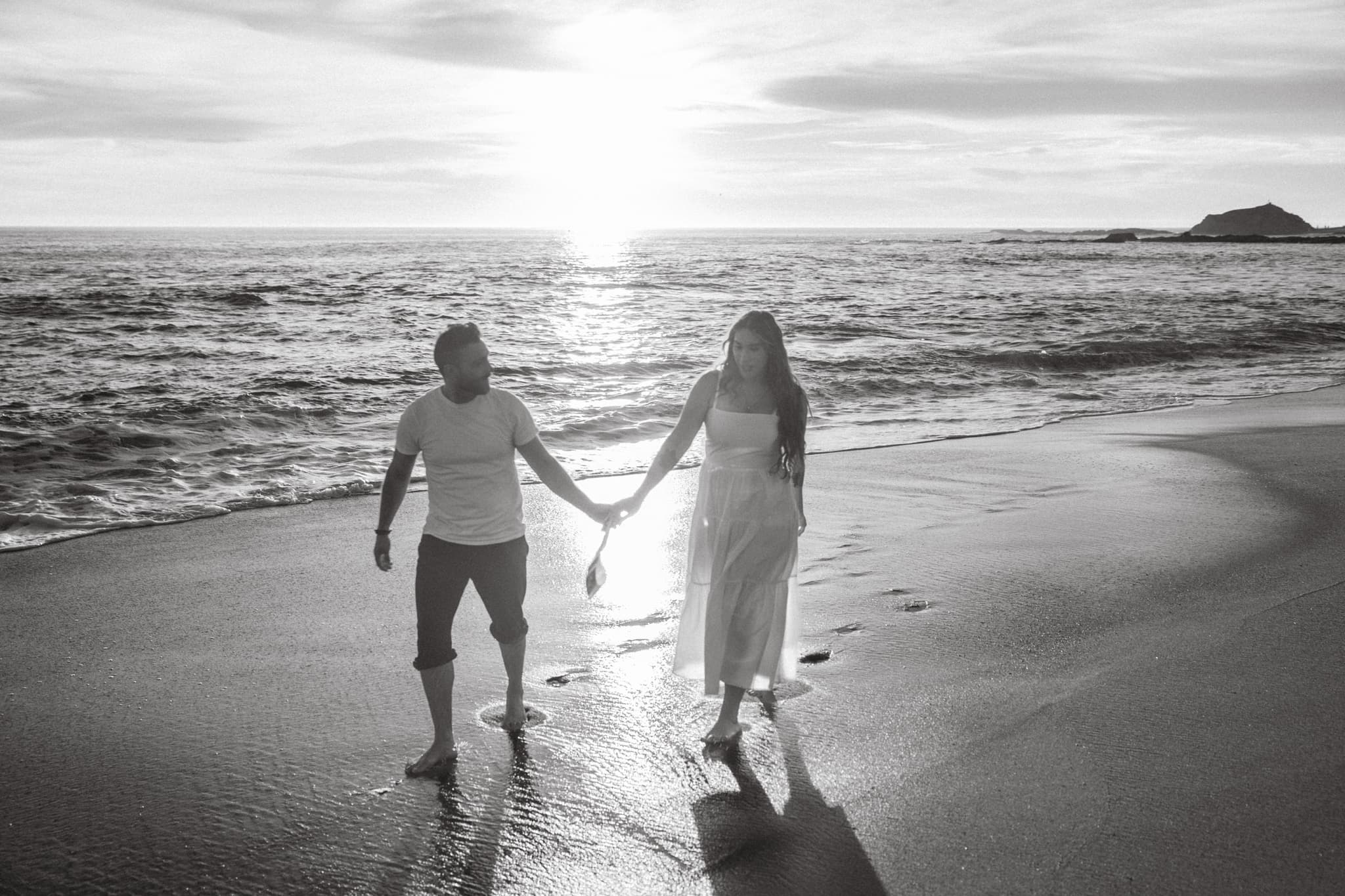 Couple walking into the sunset — black and white
