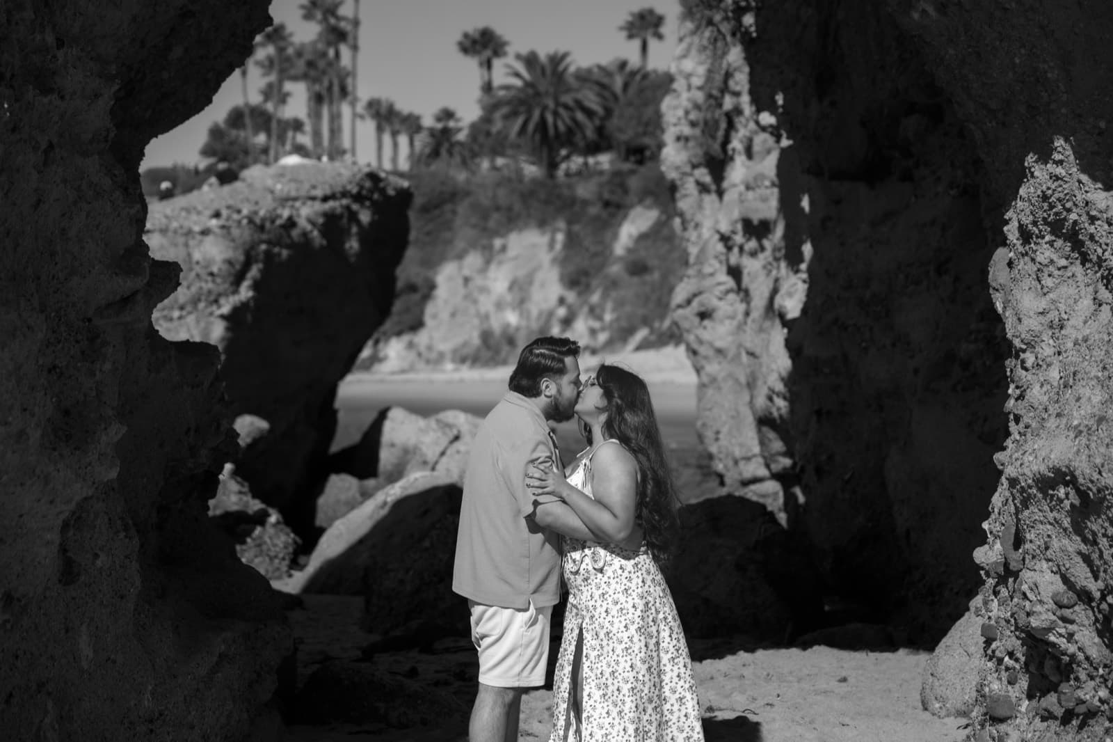 Couple at a beach cove — black and white