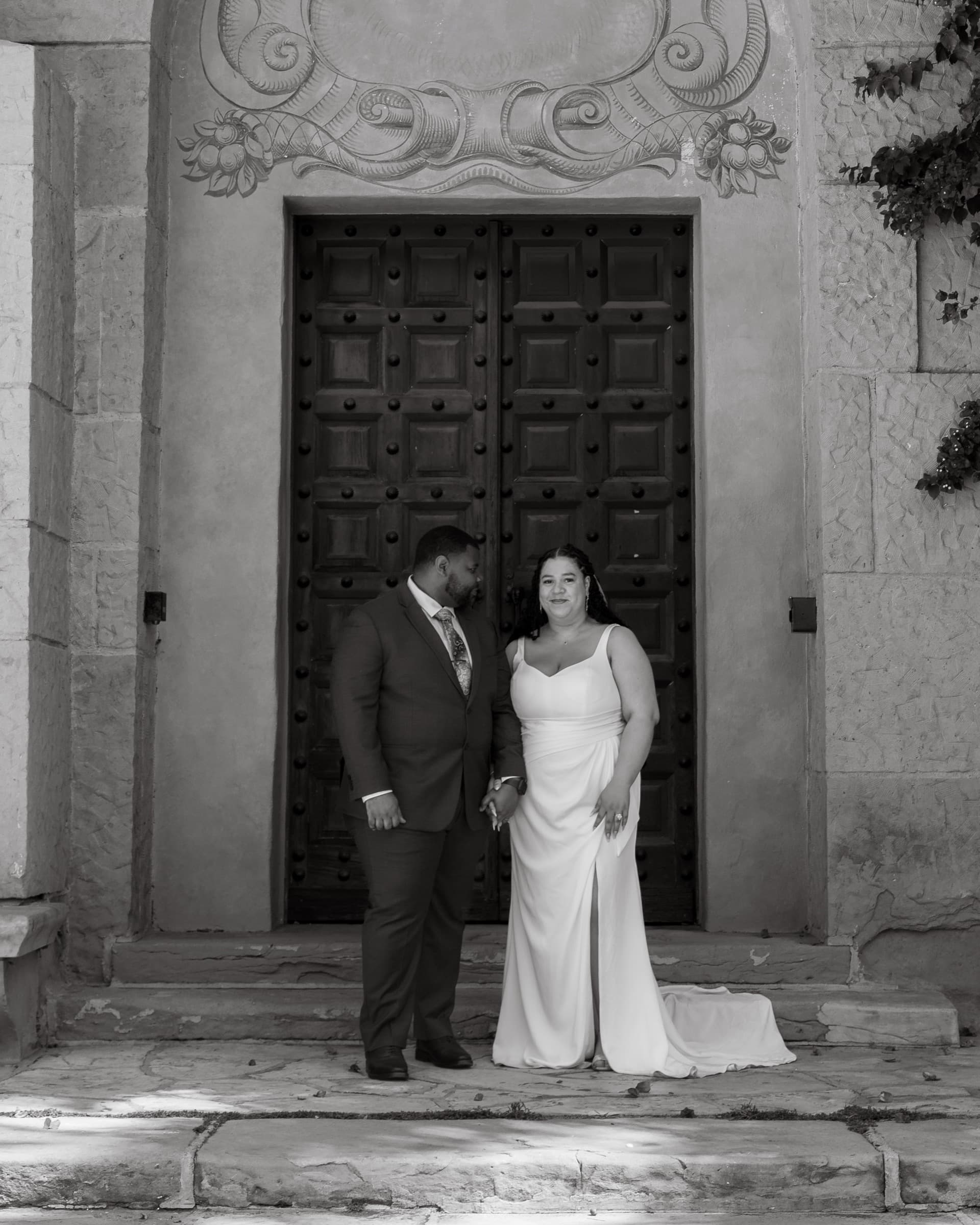 Couple at ornate door — B&W
