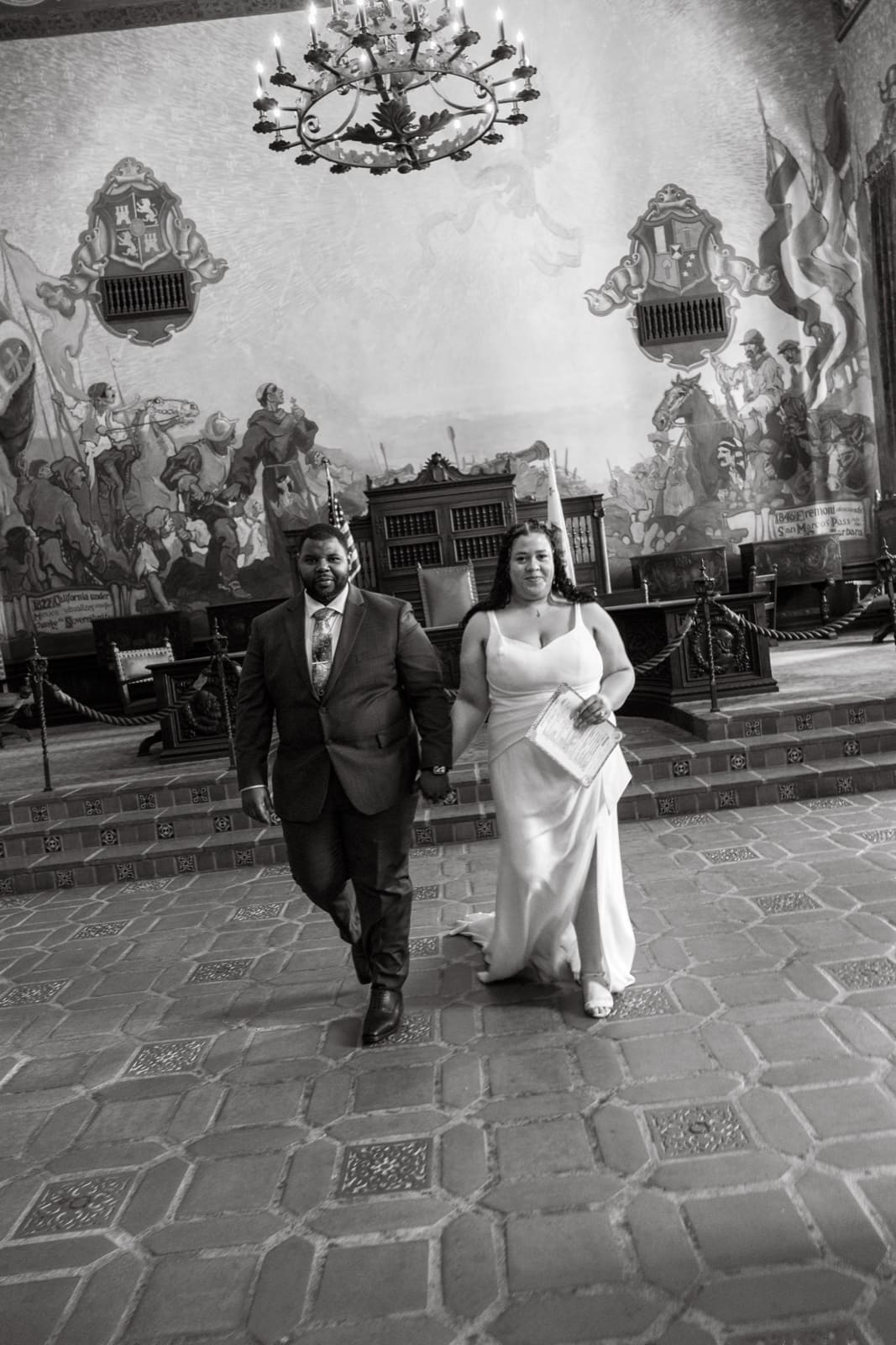 Black and white — couple walking out of the Santa Barbara courthouse