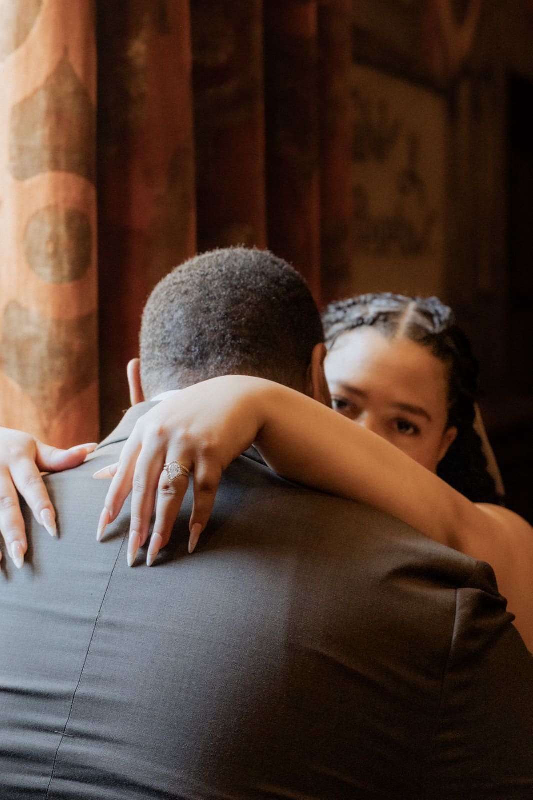 The bride's arms around her husband after the ceremony