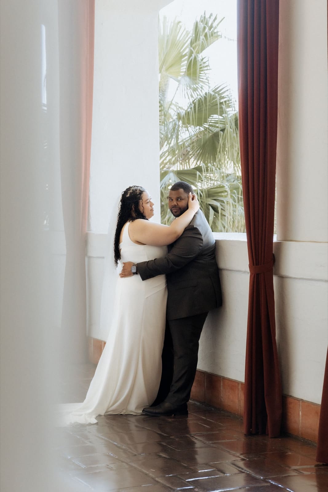 Couple embracing by a window, Santa Barbara courthouse