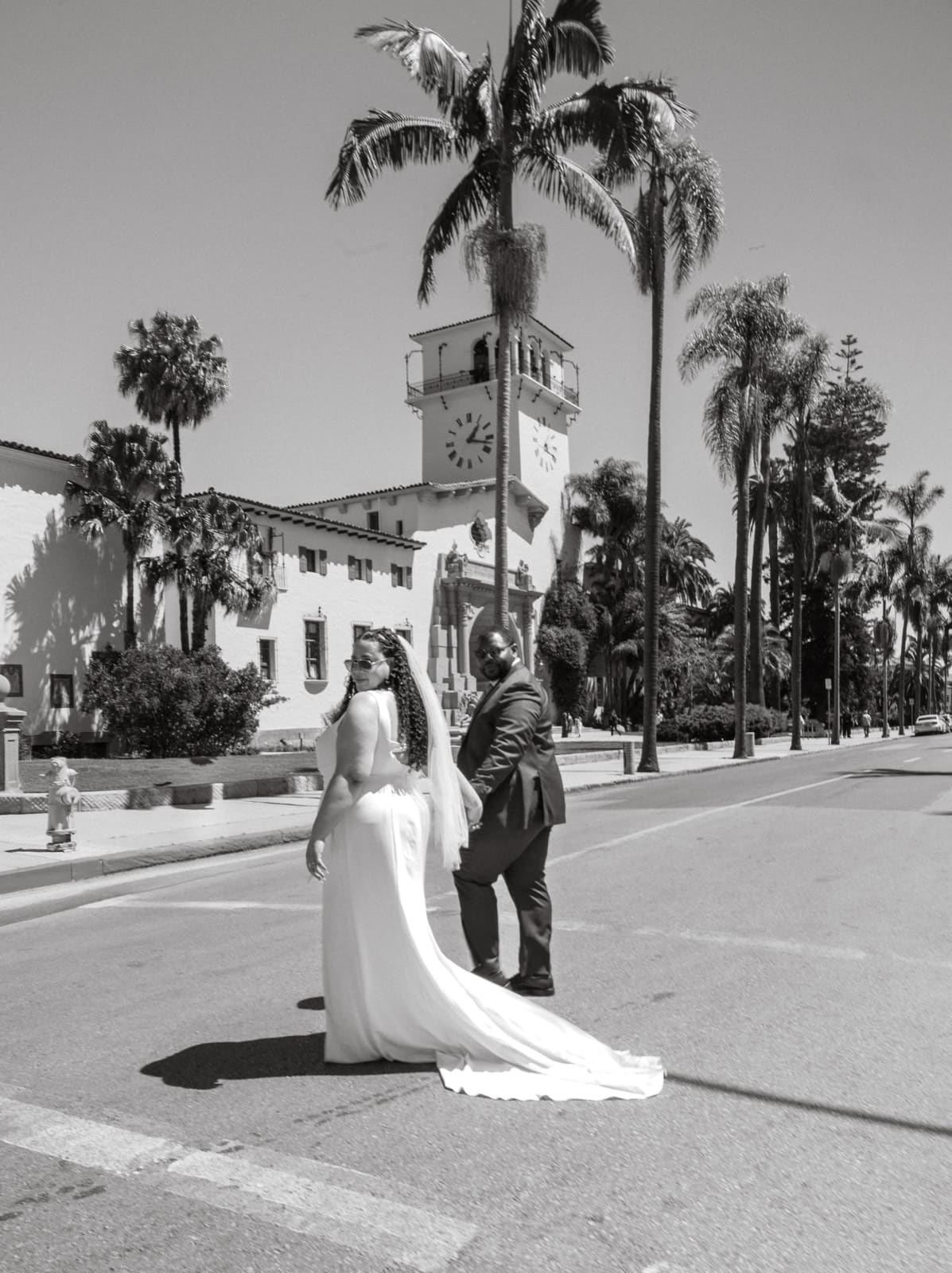 Couple crossing the street toward the courthouse tower
