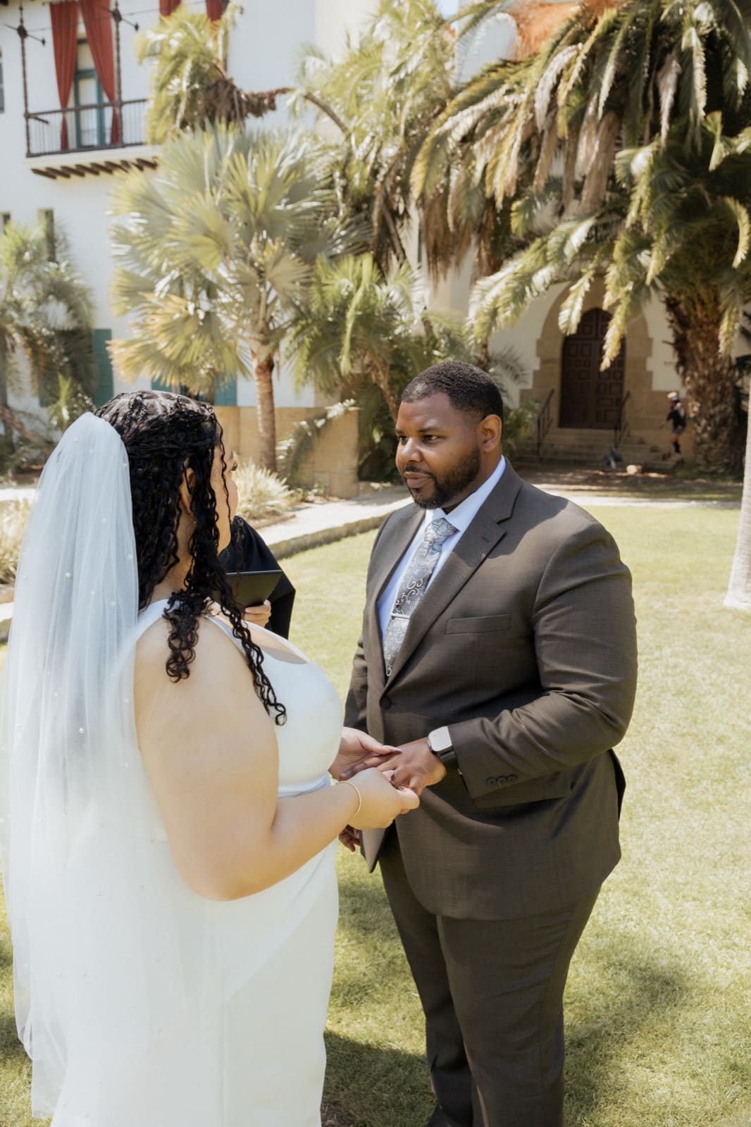 First look — bride facing away, groom seeing her