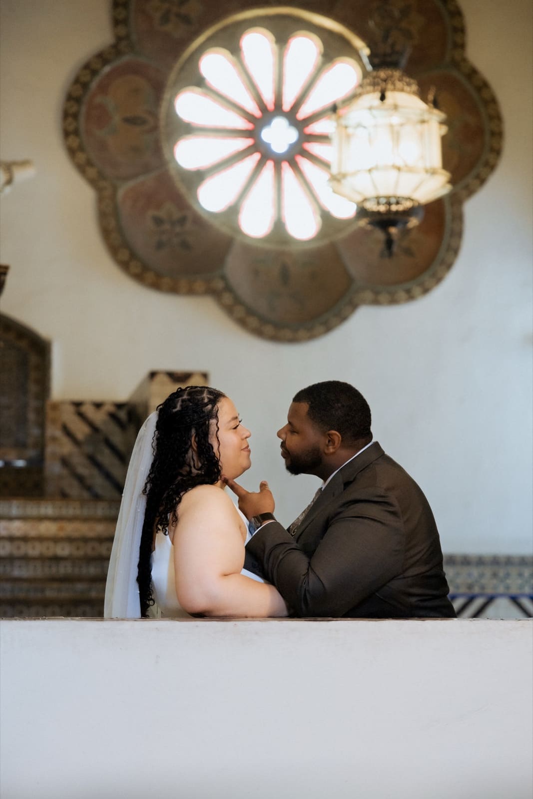 Couple reflected in the mirrored hall