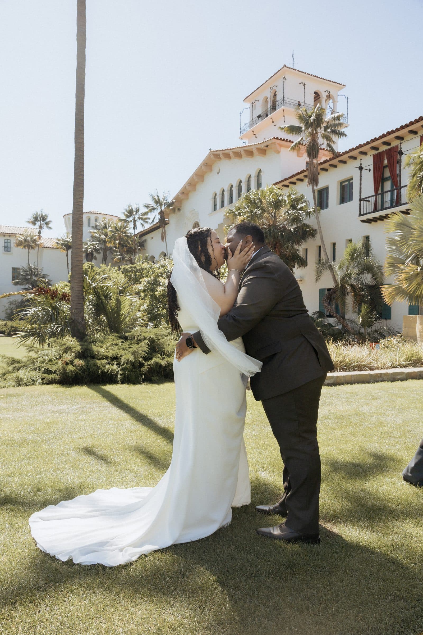 Gabrielle and Matthew kiss in the Sunken Gardens below the Santa Barbara County Courthouse clock tower — Vida Visual
