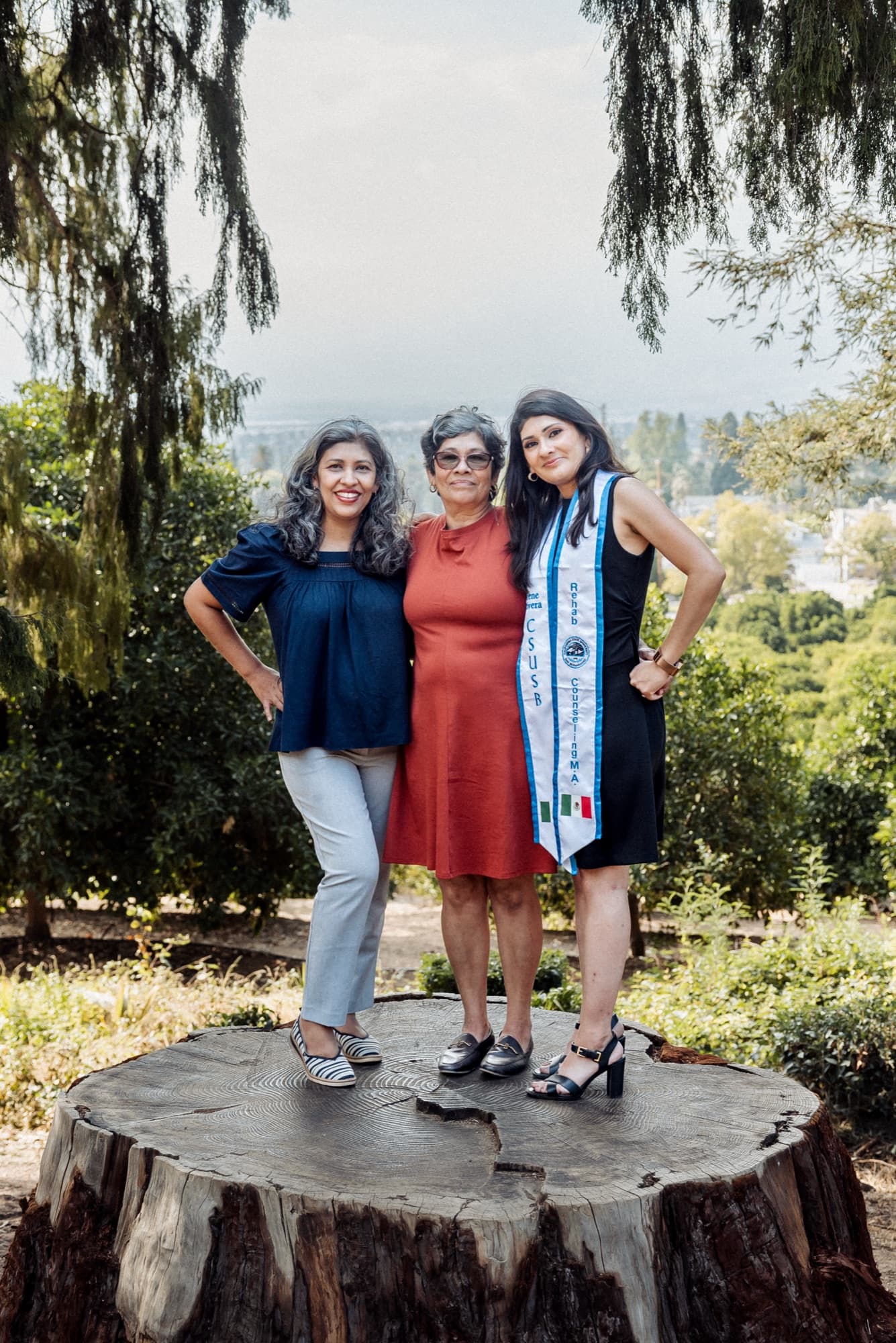 A graduate photographed with her mother and grandmother