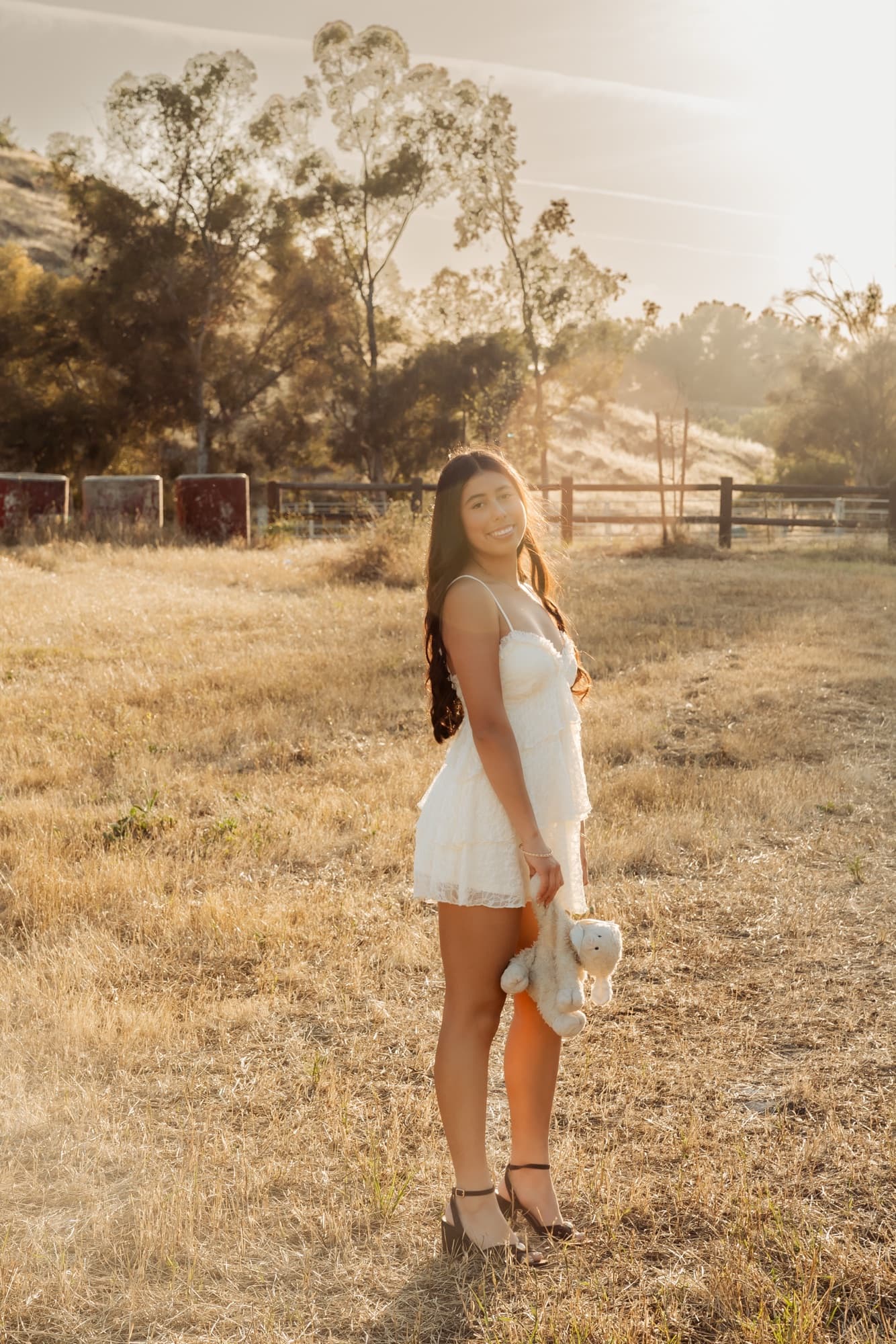 Senior portrait in an open field at golden hour — Inland Empire