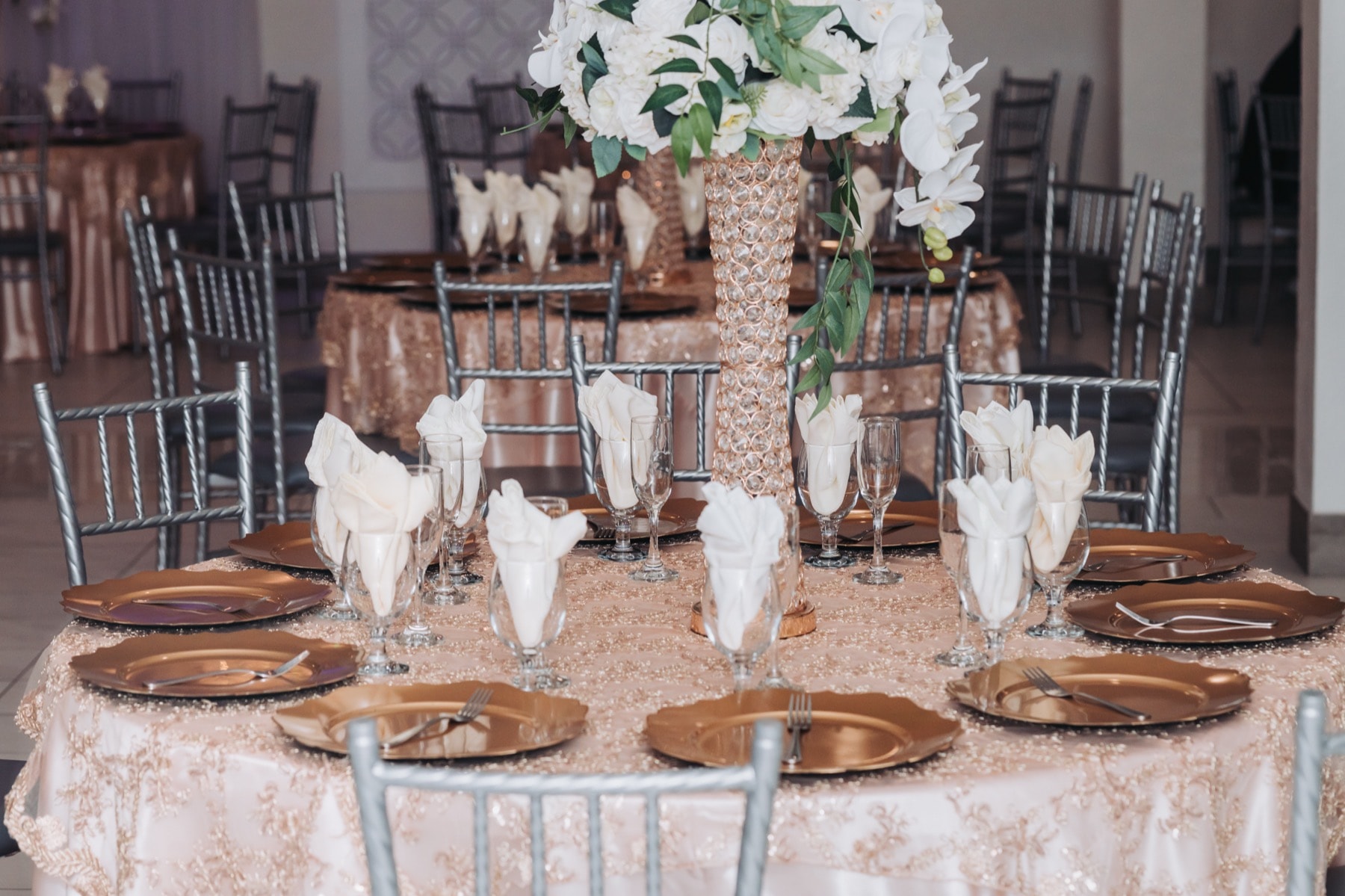 Beautifully lit wedding reception inside a banquet hall photographed by Vida Visual Riverside