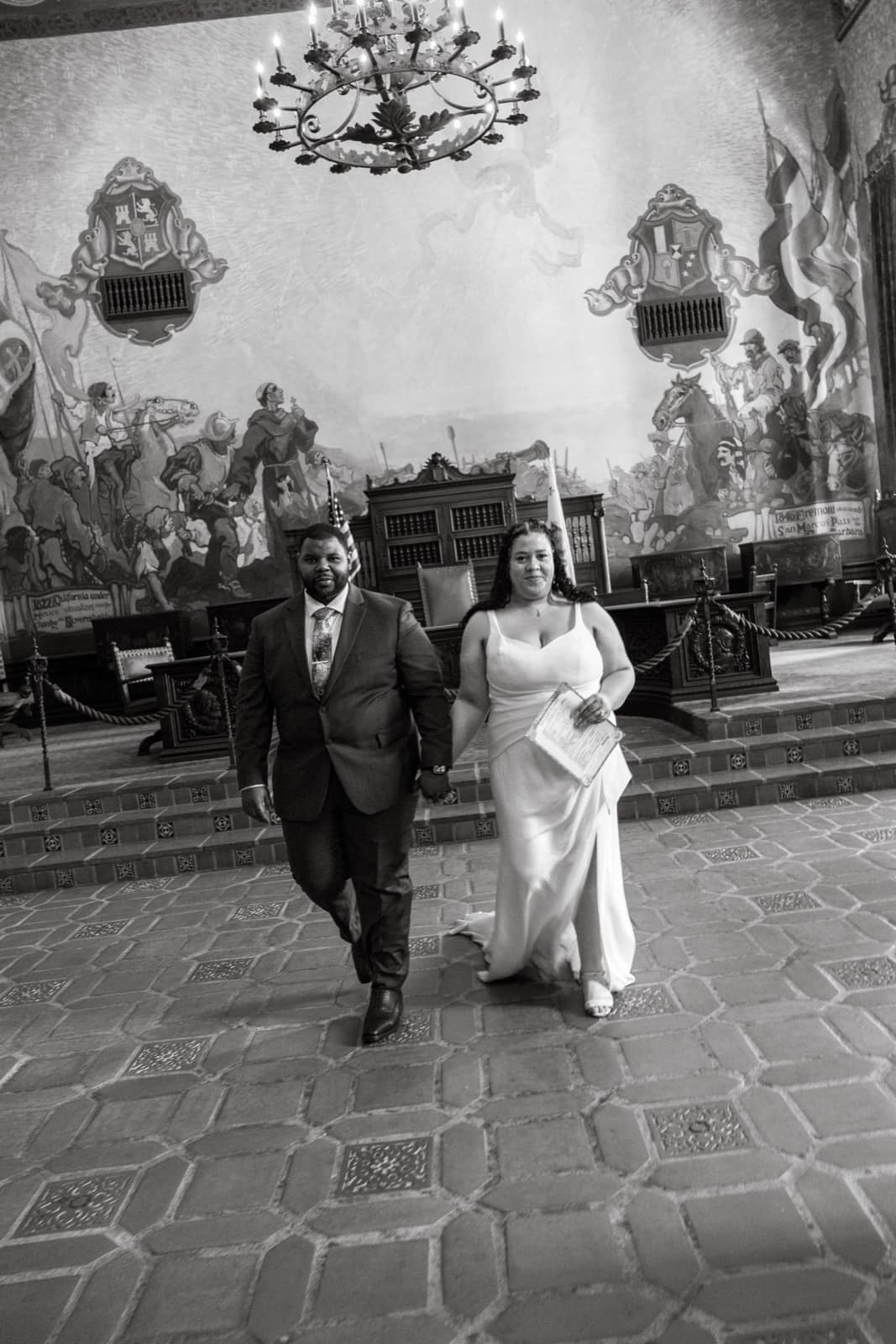 Couple walking out of the Santa Barbara courthouse after their civil ceremony
