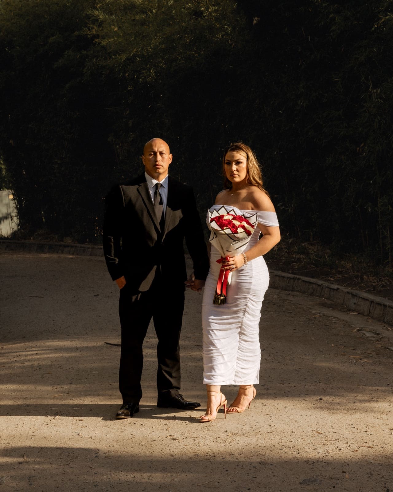Bride with her red and white bouquet in the evening light