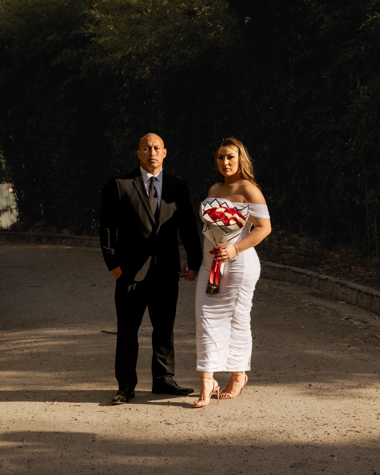 Bride with her red and white bouquet in the evening light