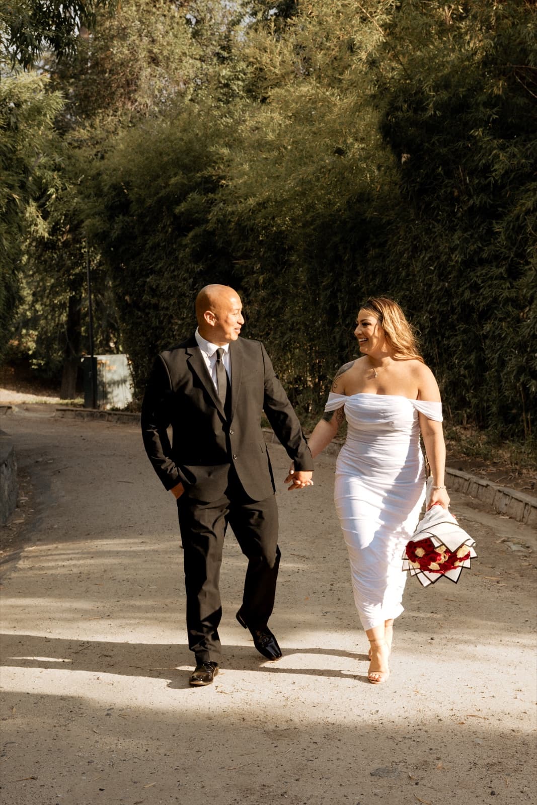 Couple walking the olive grove at Prospect Park in Redlands after their courthouse wedding