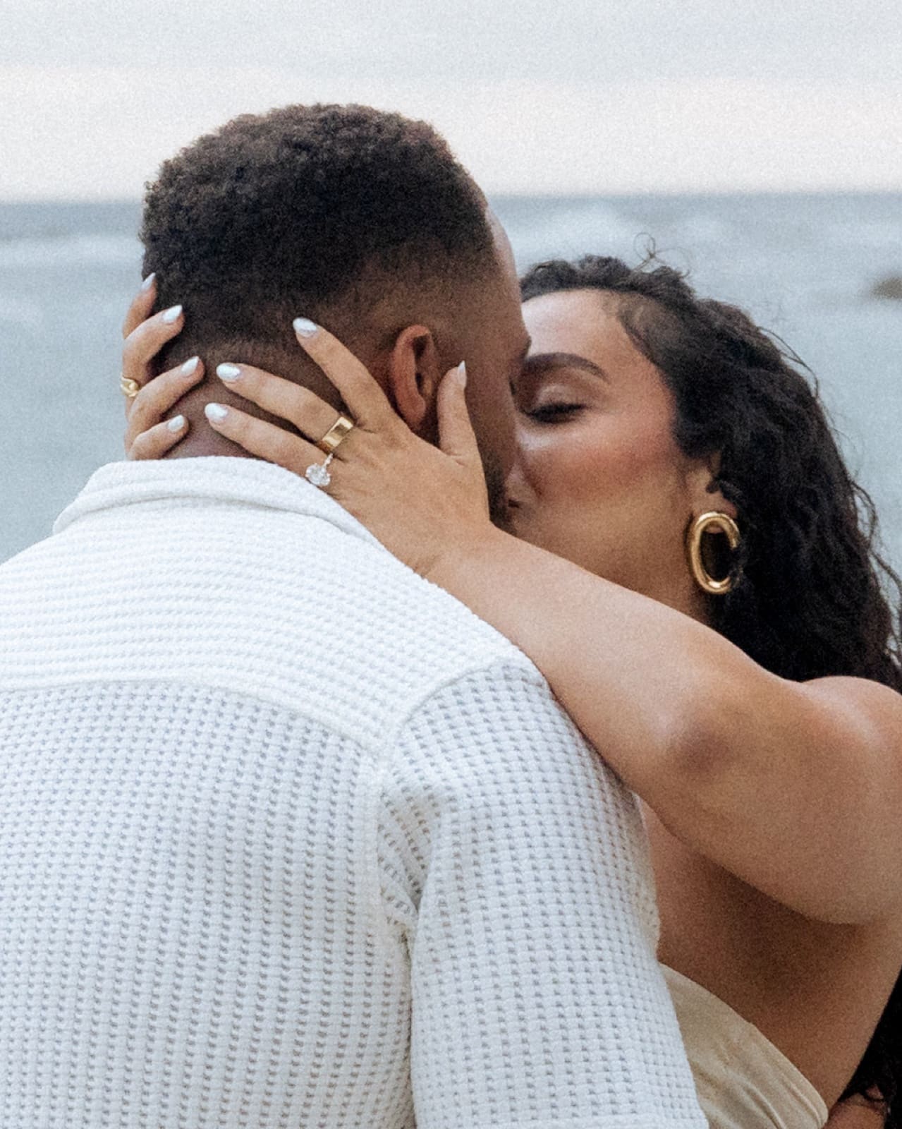 Close portrait — his hands on her face after she said yes