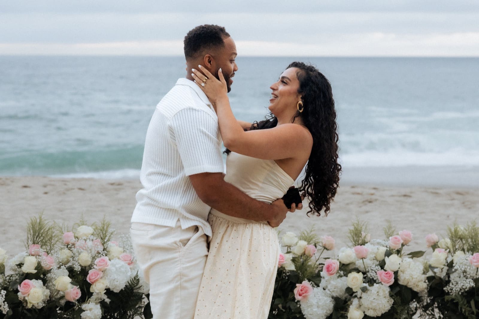 Couple holding each other at the water's edge