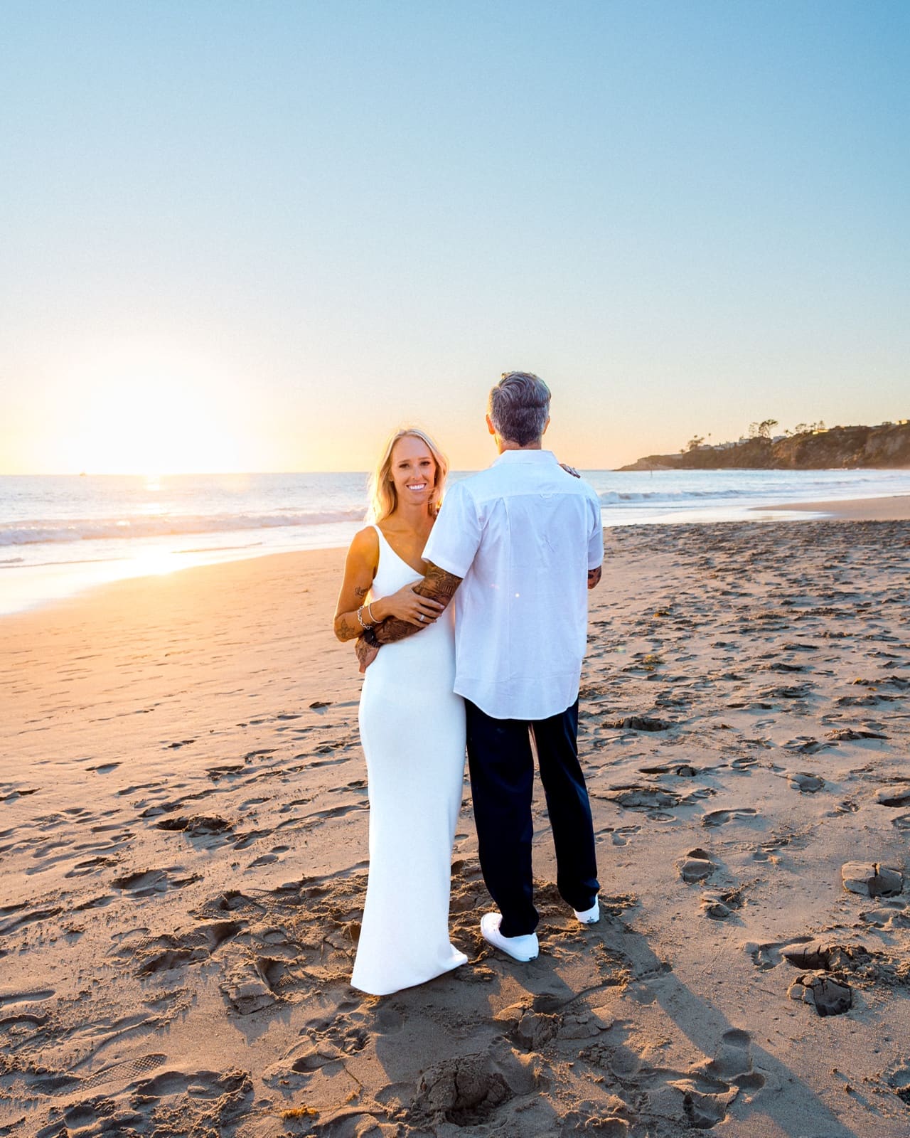 Couple on the sand at Laguna Beach as the sun drops