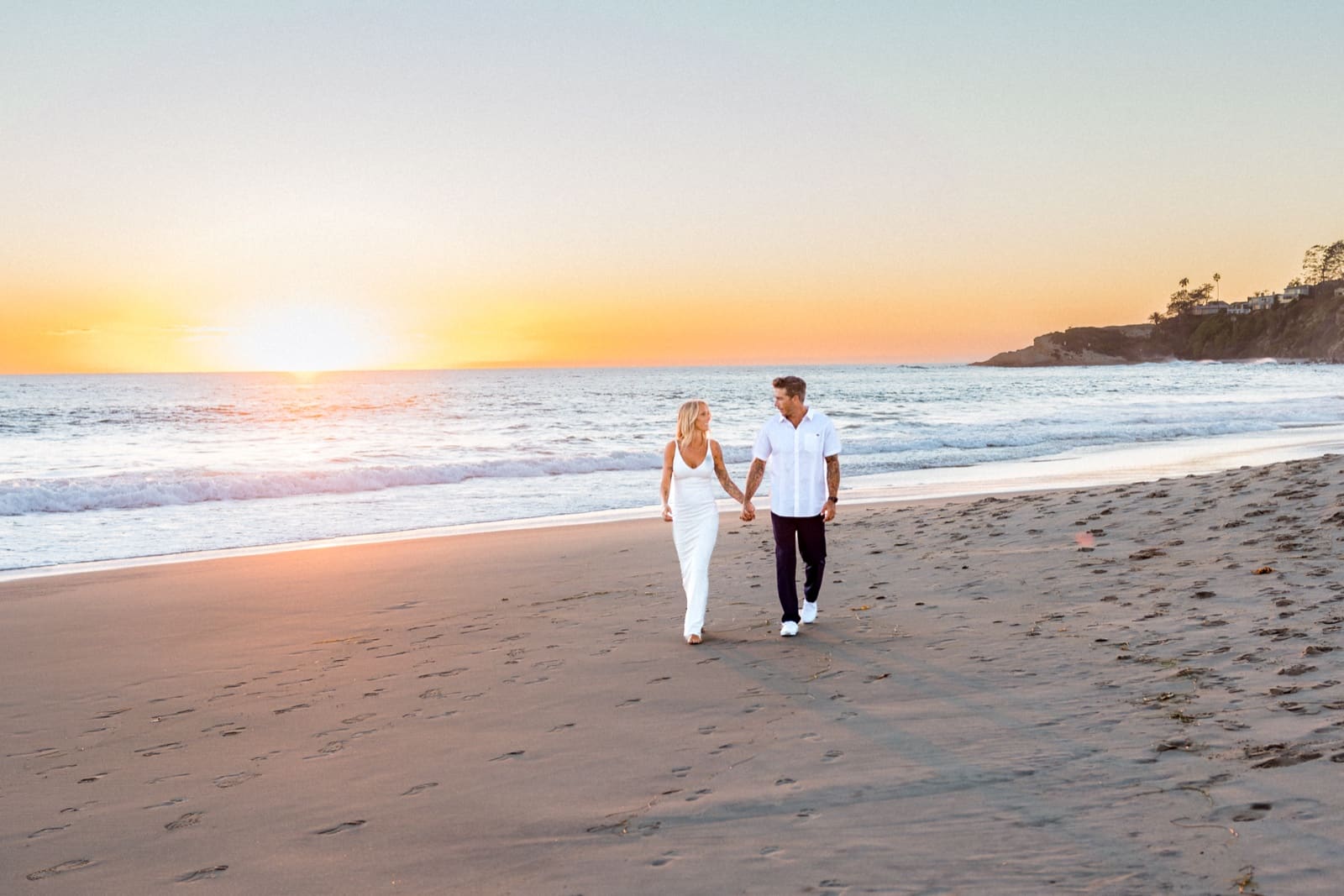 Couple walking the shoreline at Laguna Beach