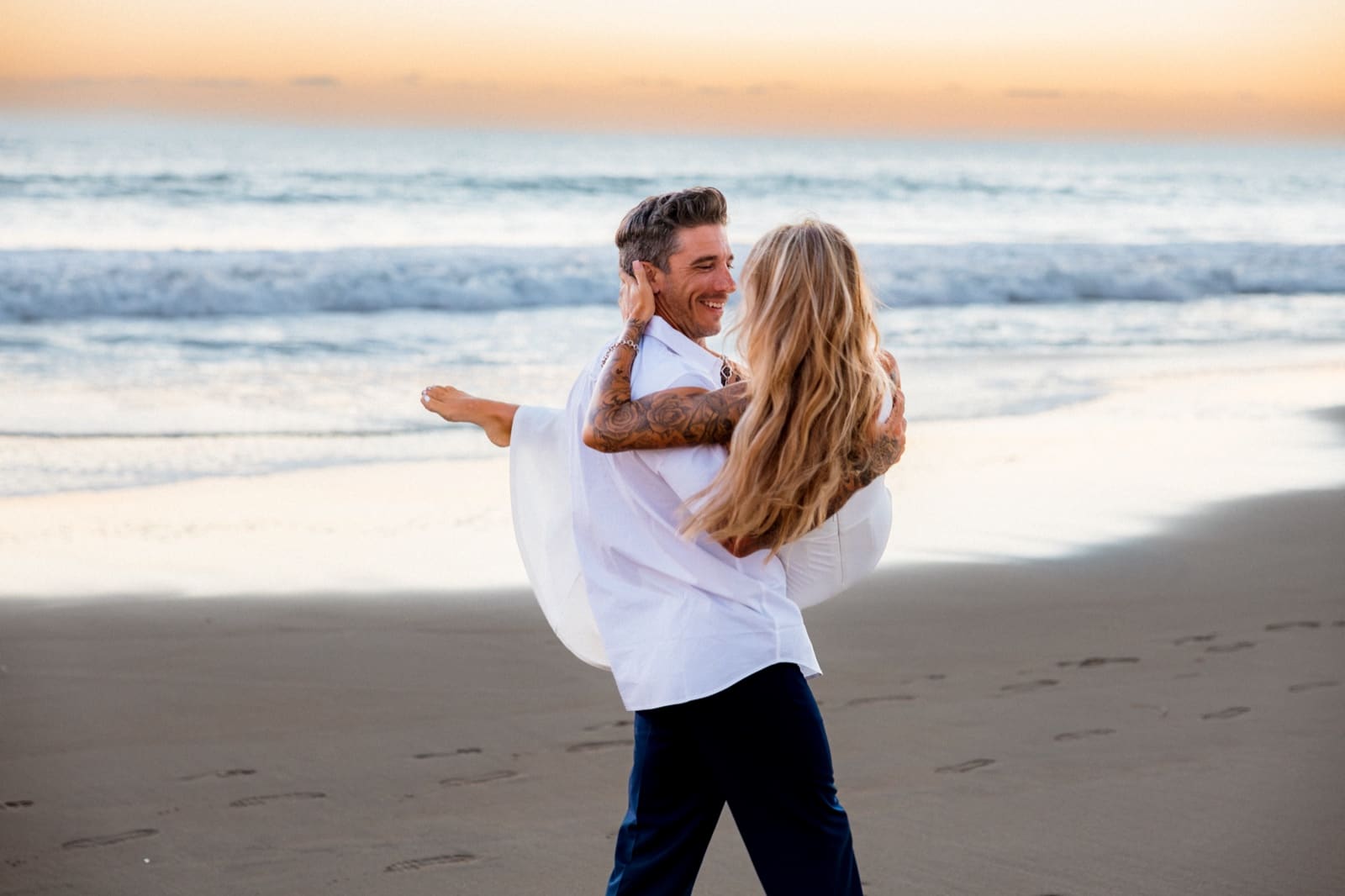 Couple lifted at golden hour, Treasure Island Beach