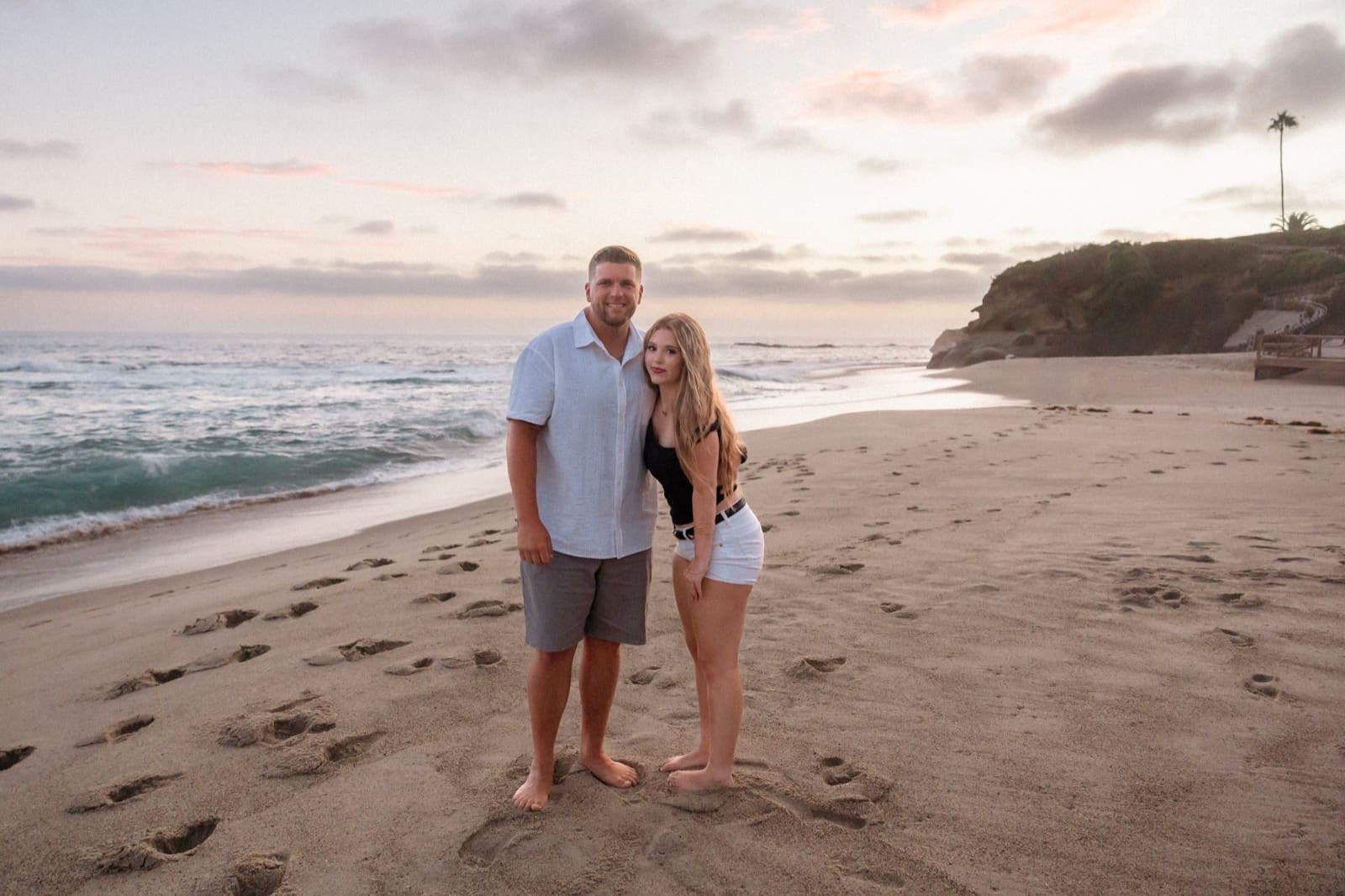 Father and daughter on the beach at sunset