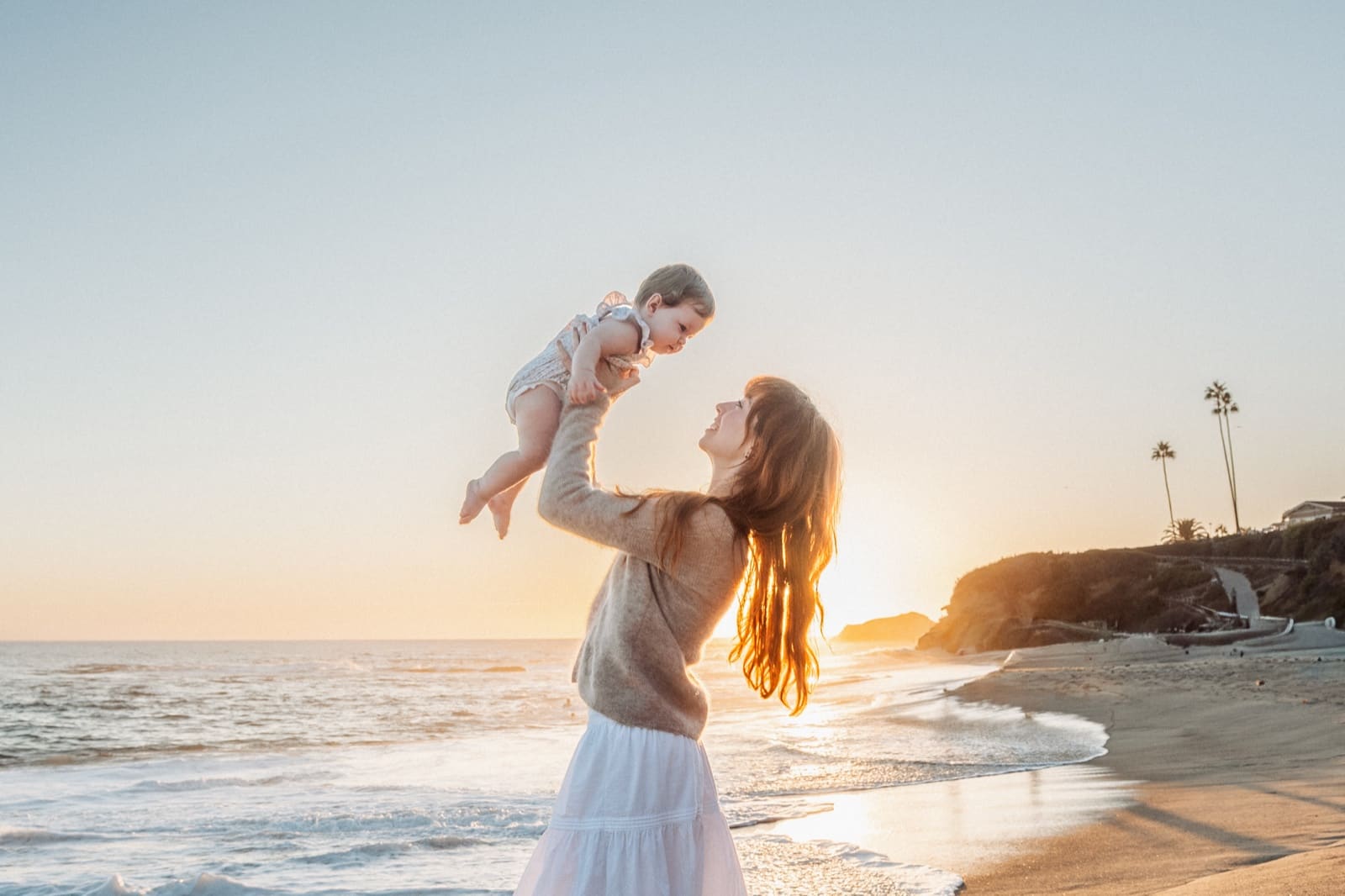 Mother holding her daughter up, Treasure Island Beach