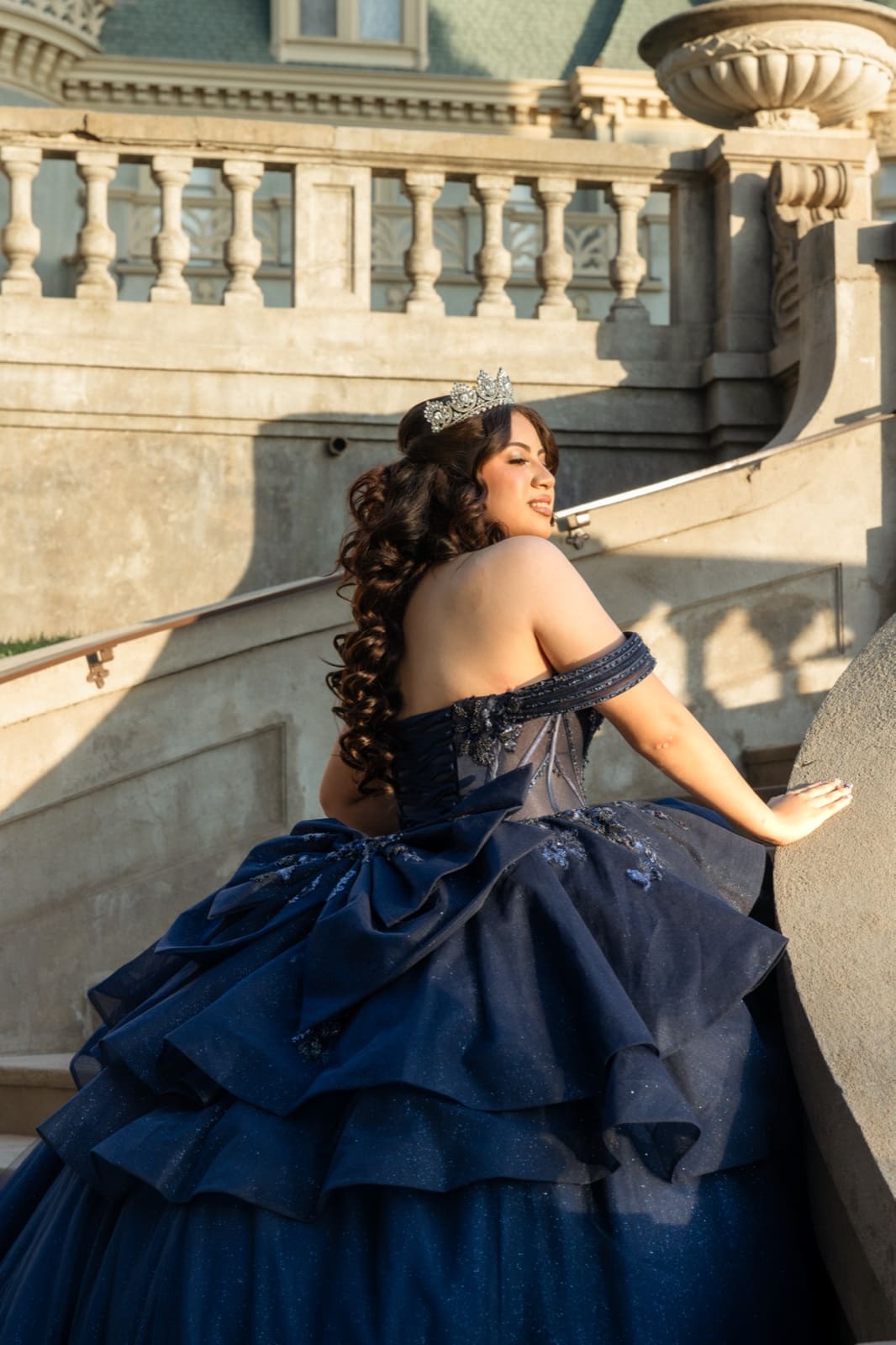 Quinceañera portrait against warm afternoon stone