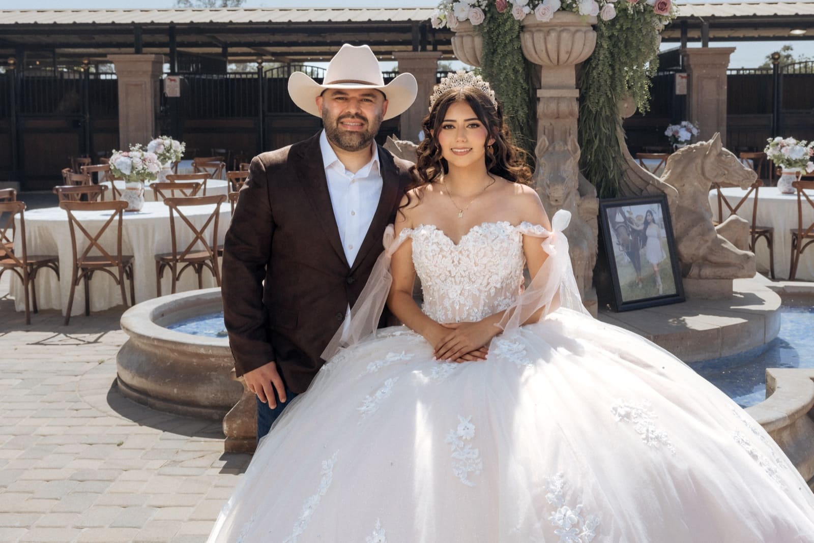 Quinceañera and her father at the reception tables