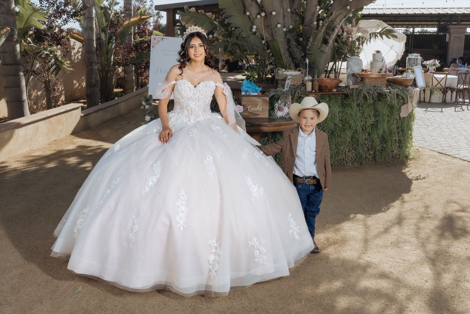 Quinceañera in the garden with a small cousin